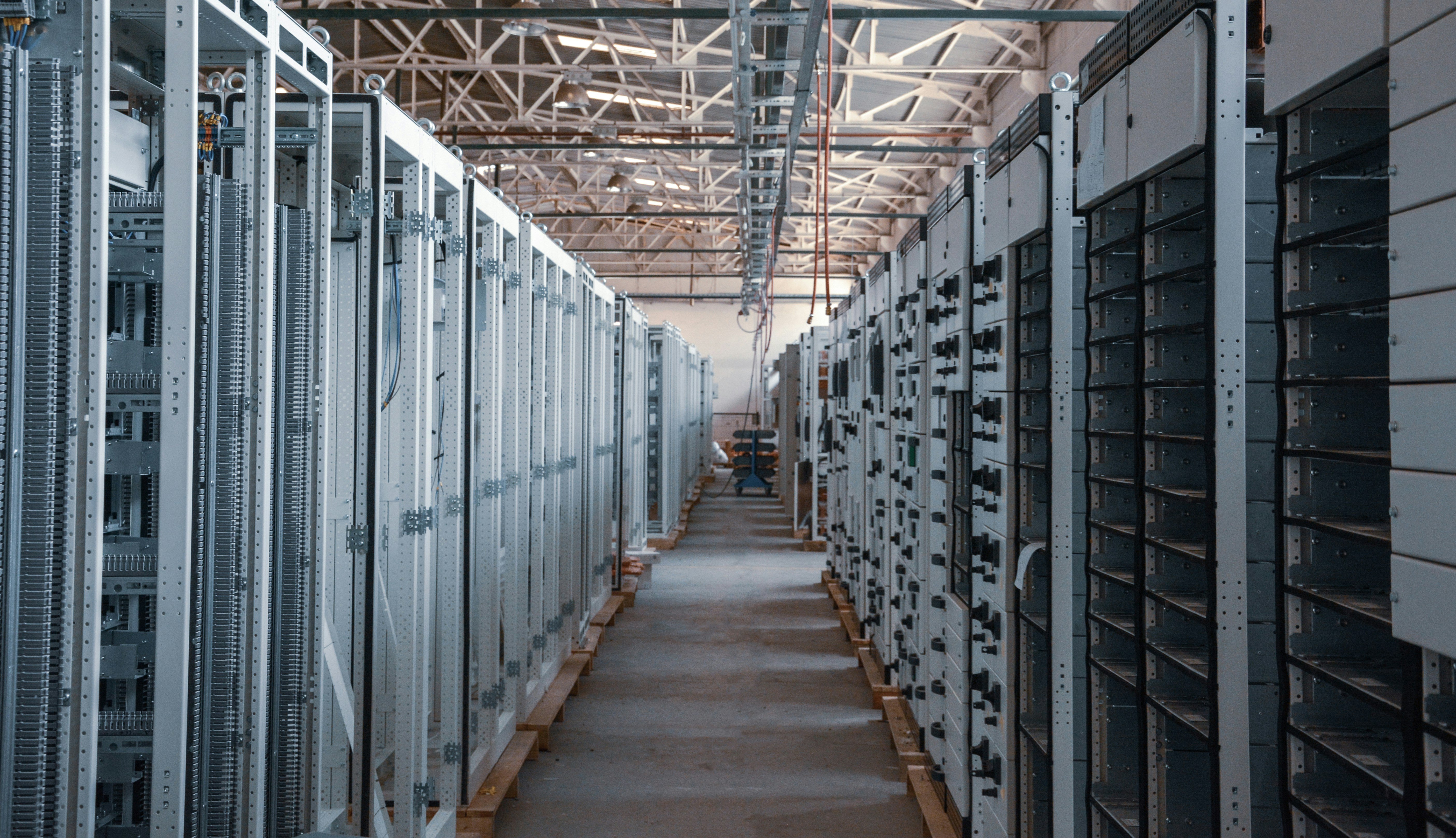 Rows of server racks inside an industrial data center.